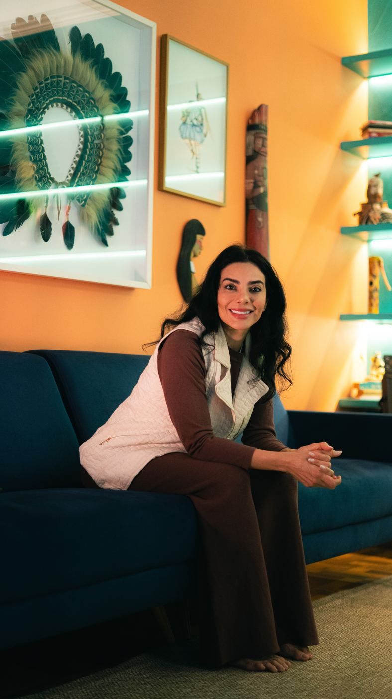 Elini Maria smiling, seated on a sofa